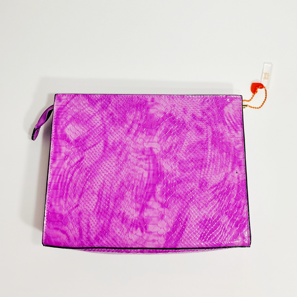  Light tie-dye purple snakeskin clutch with gold accents. The purse is on a white backdrop. 