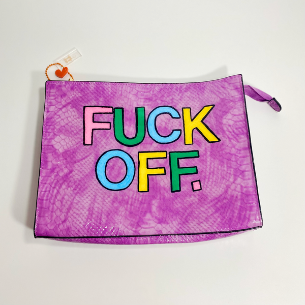   Light tie-dye purple snakeskin clutch with gold accents and colored block letters spelling fuck off. The purse is on a white backdrop. 