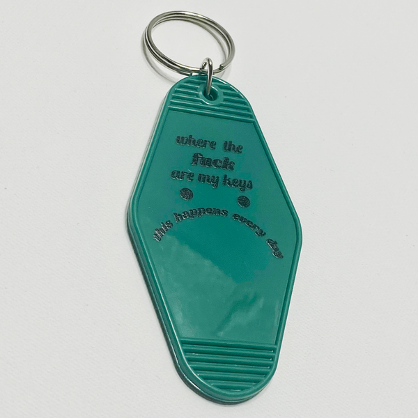 Teal motel style keychain saying "where the fuck are my keys this happens every day," on a plain white background.